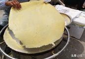 A griddle thin pancake made of millet flour of booth of countrywoman of a gas canister a yuan